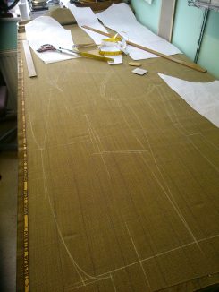 a set of paper patterns are made for each individual commission and then chalked out onto the cloth, cut out and made up to a first fitting.